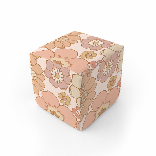 Cube-shaped object with a floral pattern on a white background