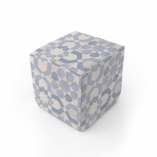 Cube-shaped ottoman with geometric pattern on a white background