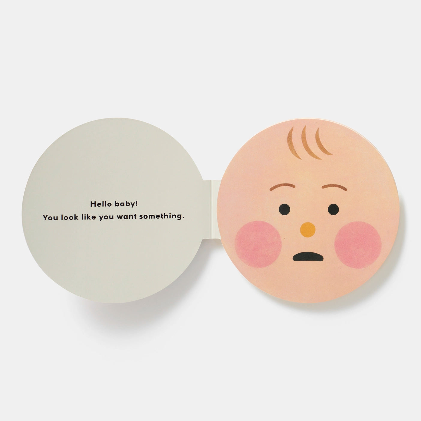 A board book with a white background, featuring a baby face and text.