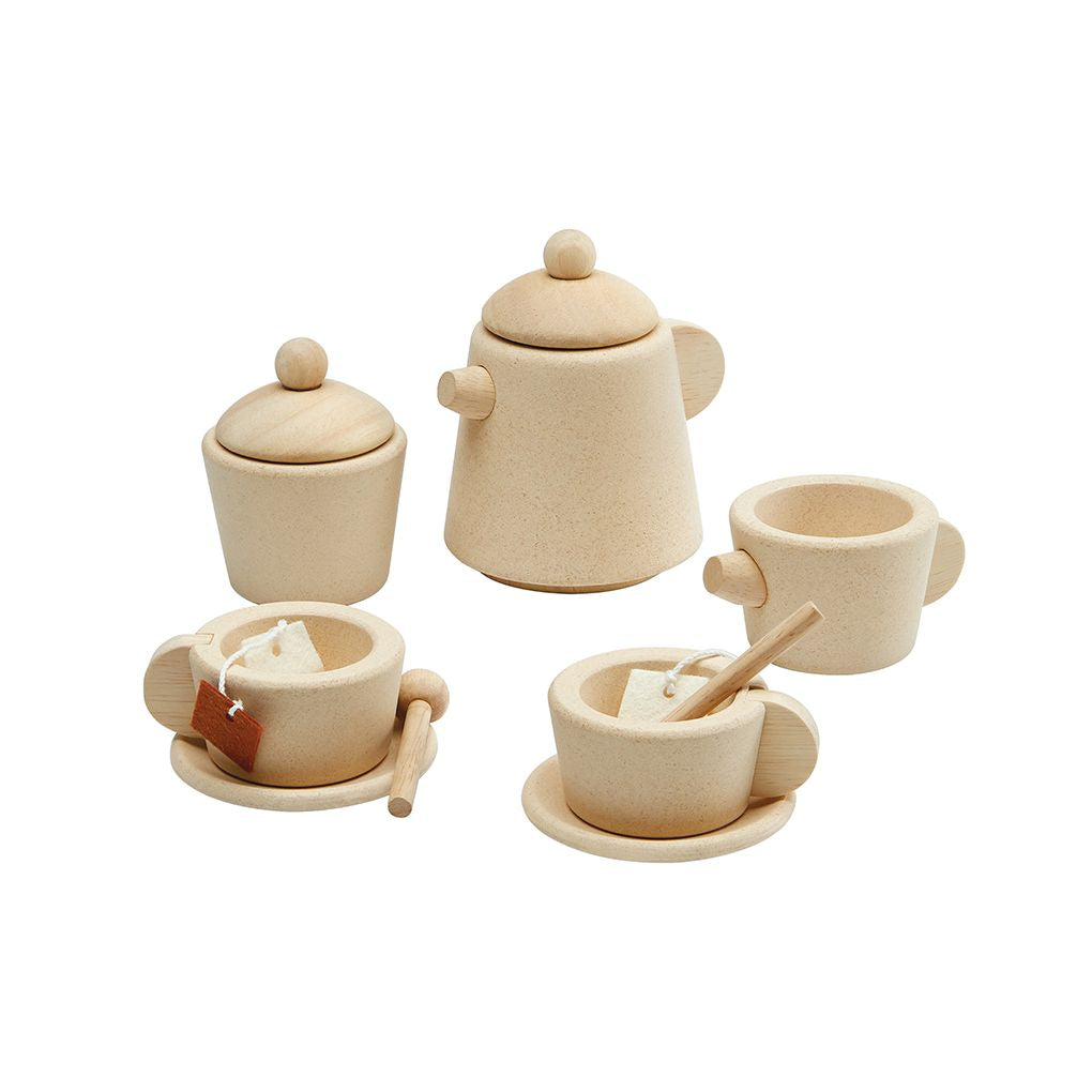 Set of wooden tea pots and cups on a white background