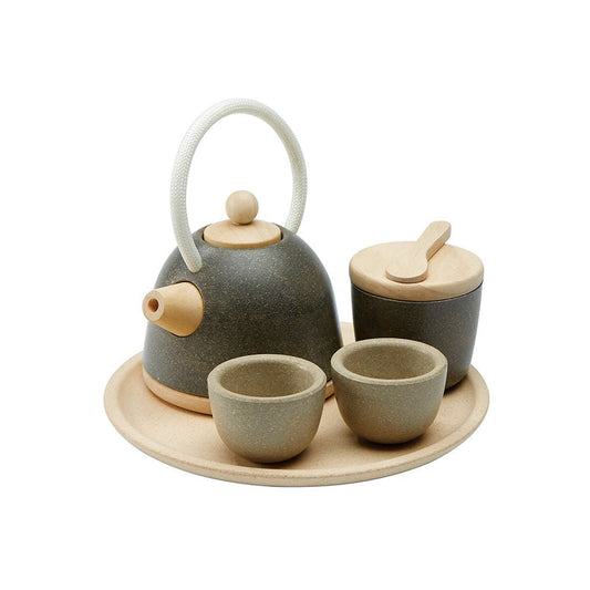 Ceramic tea set with teapot, cups, and tray on a white background