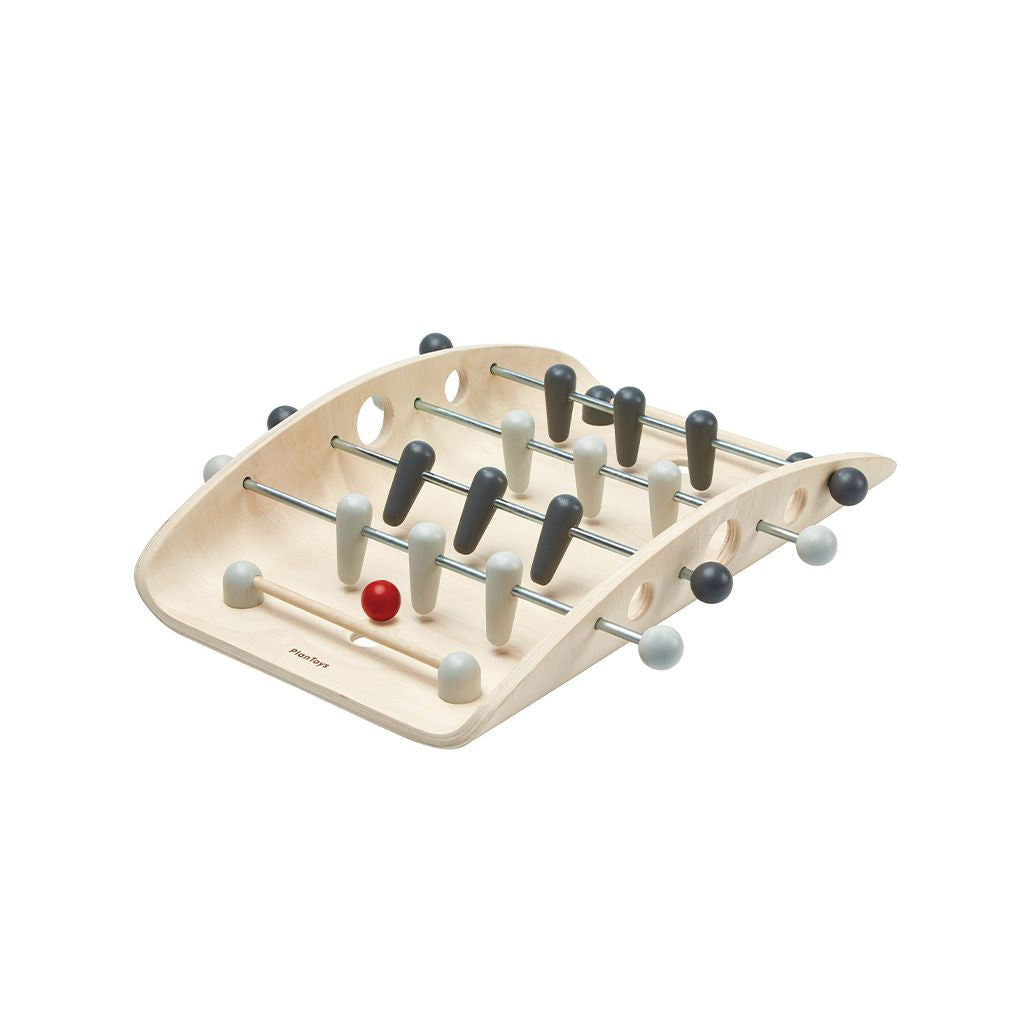 Wooden foosball table on a white background
