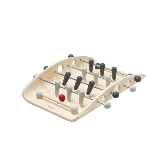 Wooden foosball table on a white background