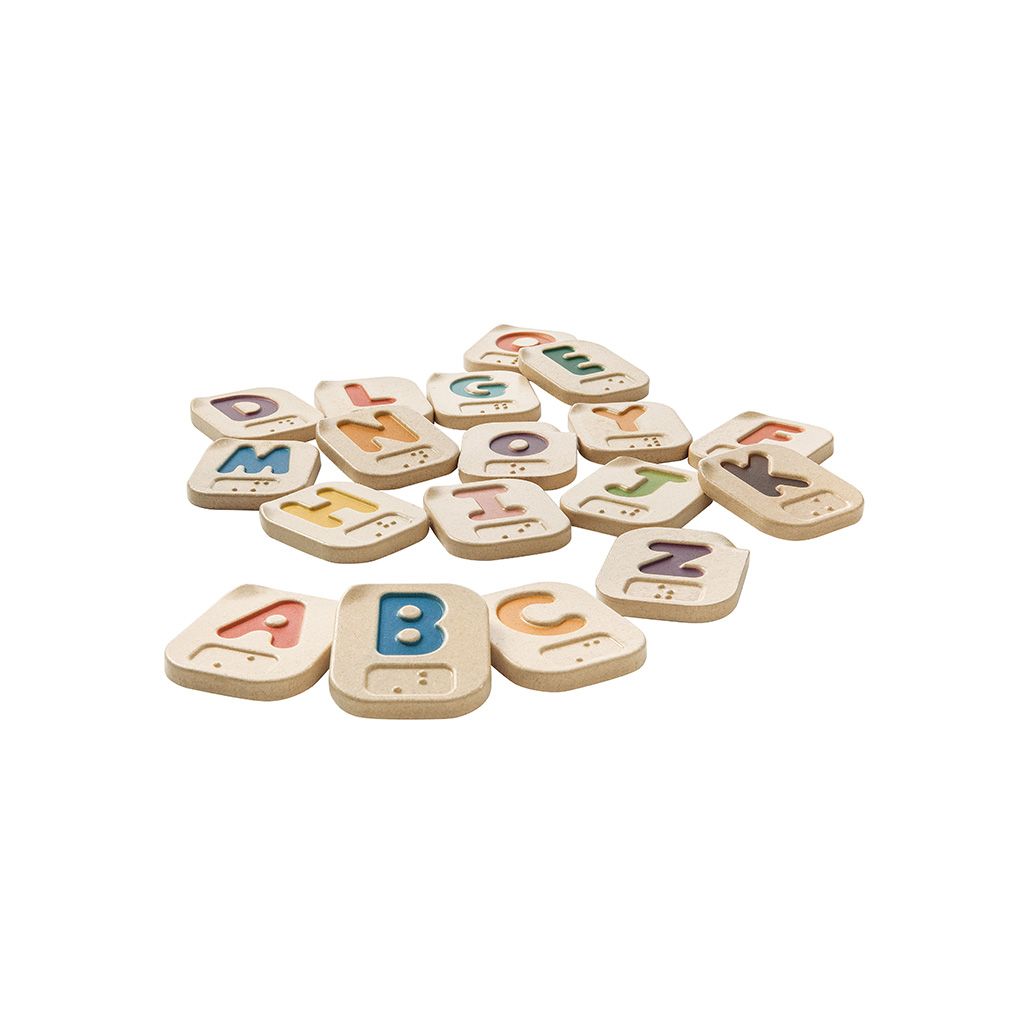 Set of colorful wooden alphabet braille letters on a white background
