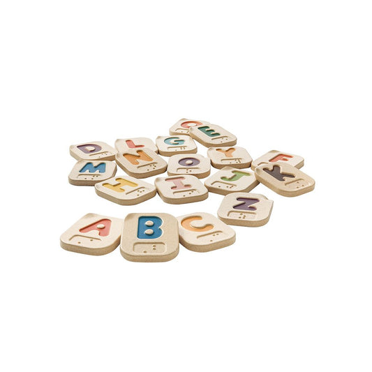Set of colorful wooden alphabet braille letters on a white background