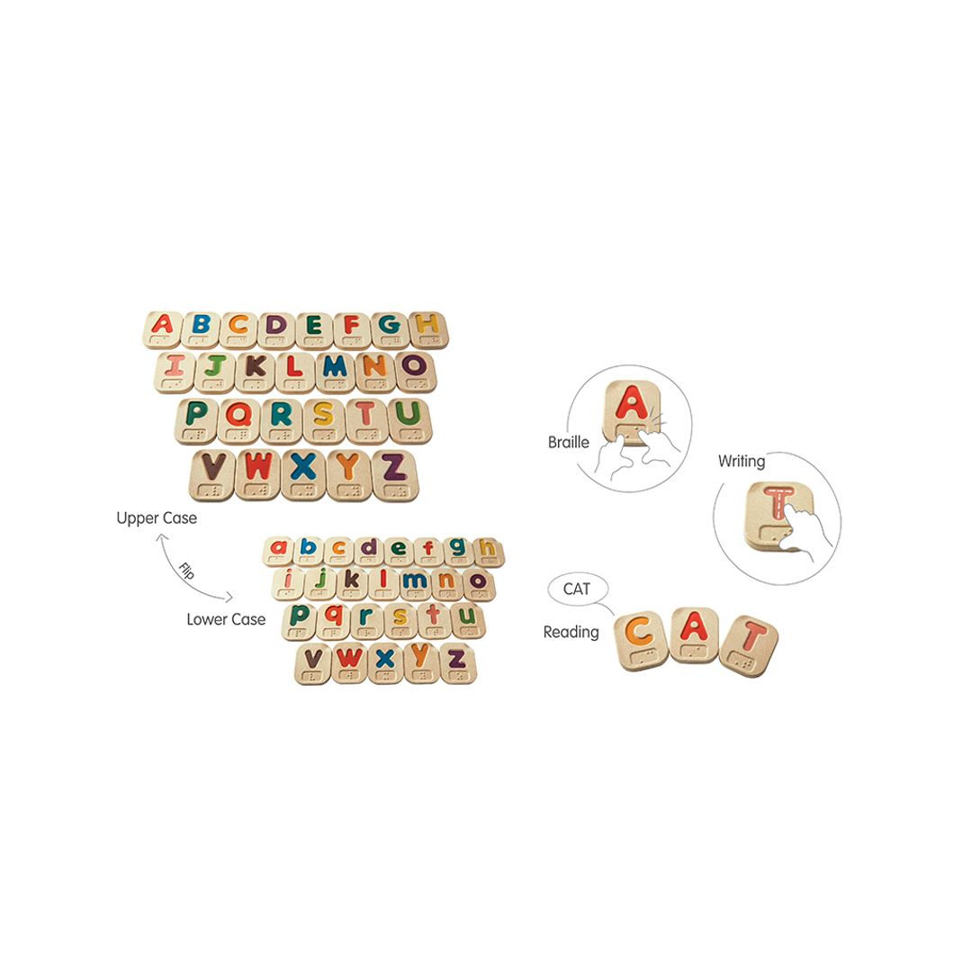 Set of wooden letters with braille alphabet and pronunciation guides on a white background