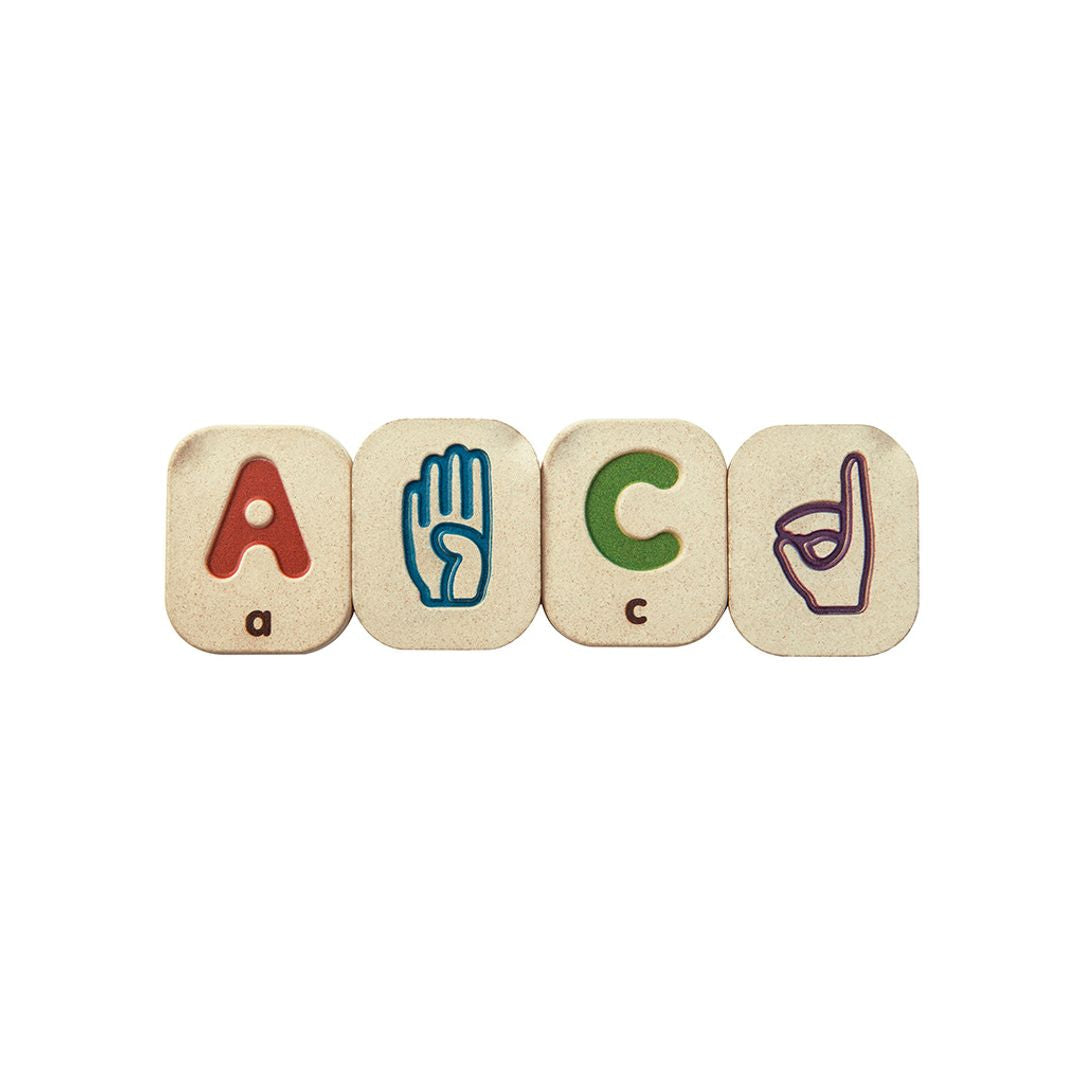Wooden letter blocks spelling 'A C' with hand symbols on a white background