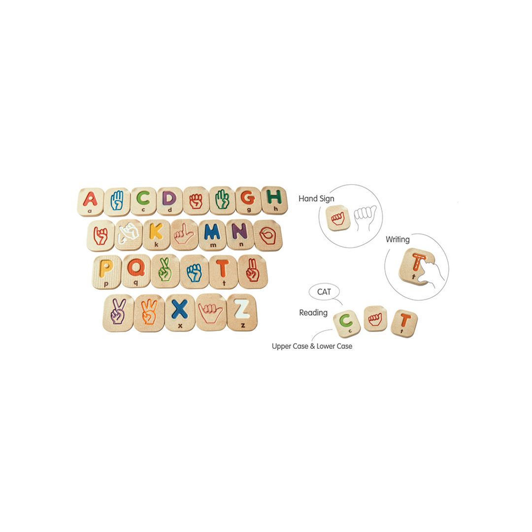 Set of wooden alphabet blocks with various designs on a white background