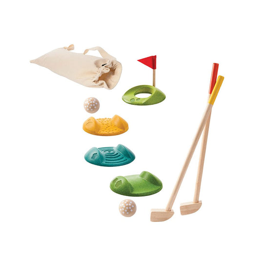 Toy golf set with clubs, balls, and holes on a white background