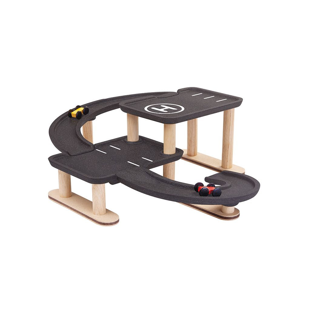 Toy race track set with cars on a white background