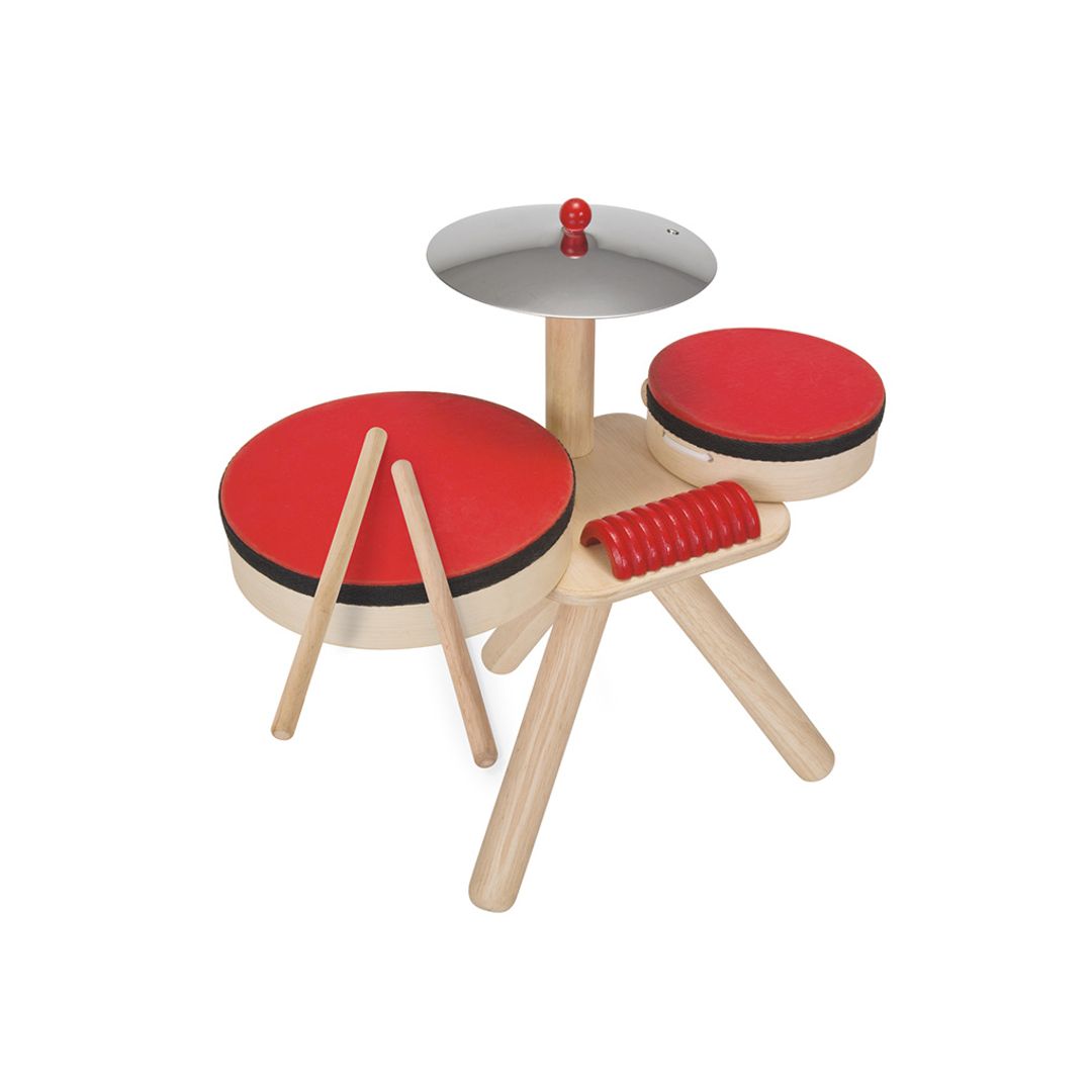 Children's toy drum set with red drums and wooden legs on a white background