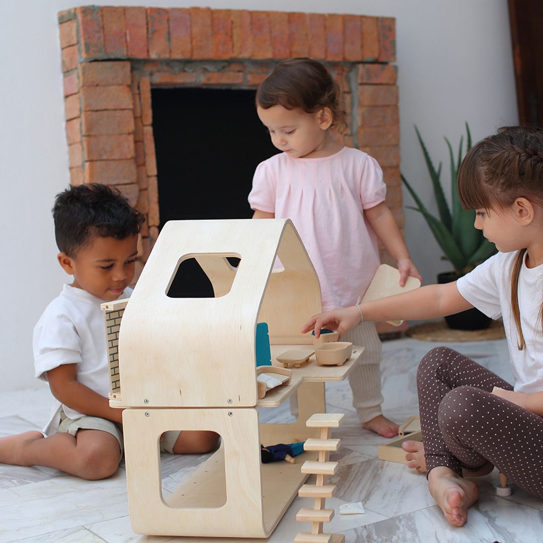 Children playing with a wooden toy set in a home setting