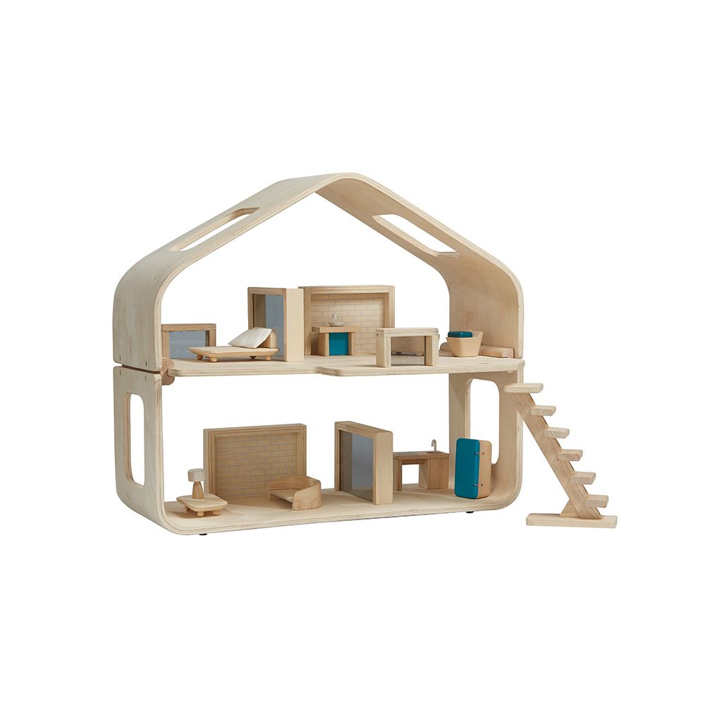 Wooden dollhouse with multiple rooms and a staircase on a white background