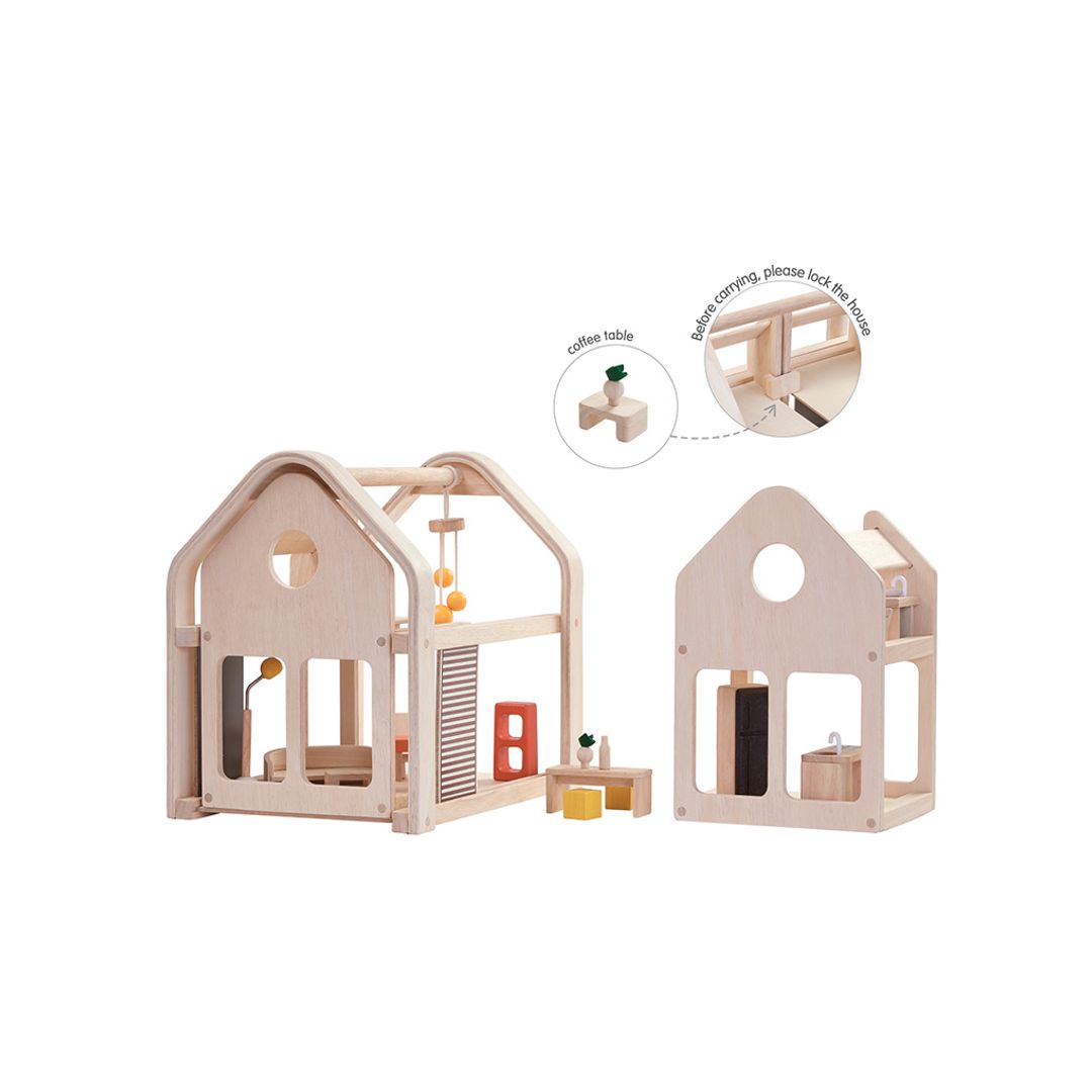 Wooden dollhouse with furniture on a white background