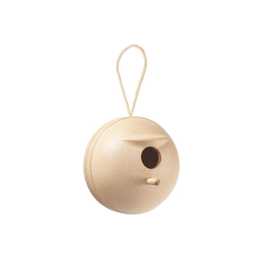 Wooden birdhouse with a round shape and a small entrance hole, hanging from a string on a white background.