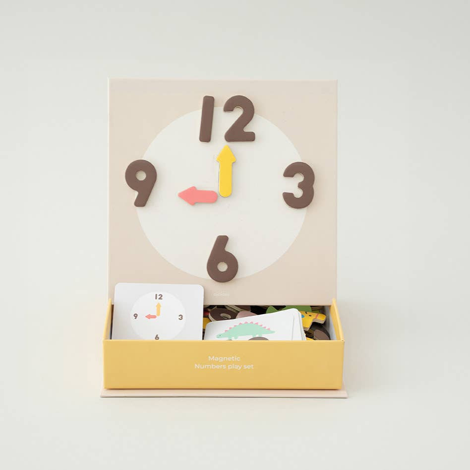 Inside packaging of the Magnetic Numbers Play Set showing numbers on a clock.
