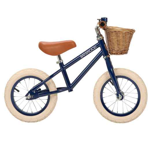 Children's balance bike with a basket on a white background