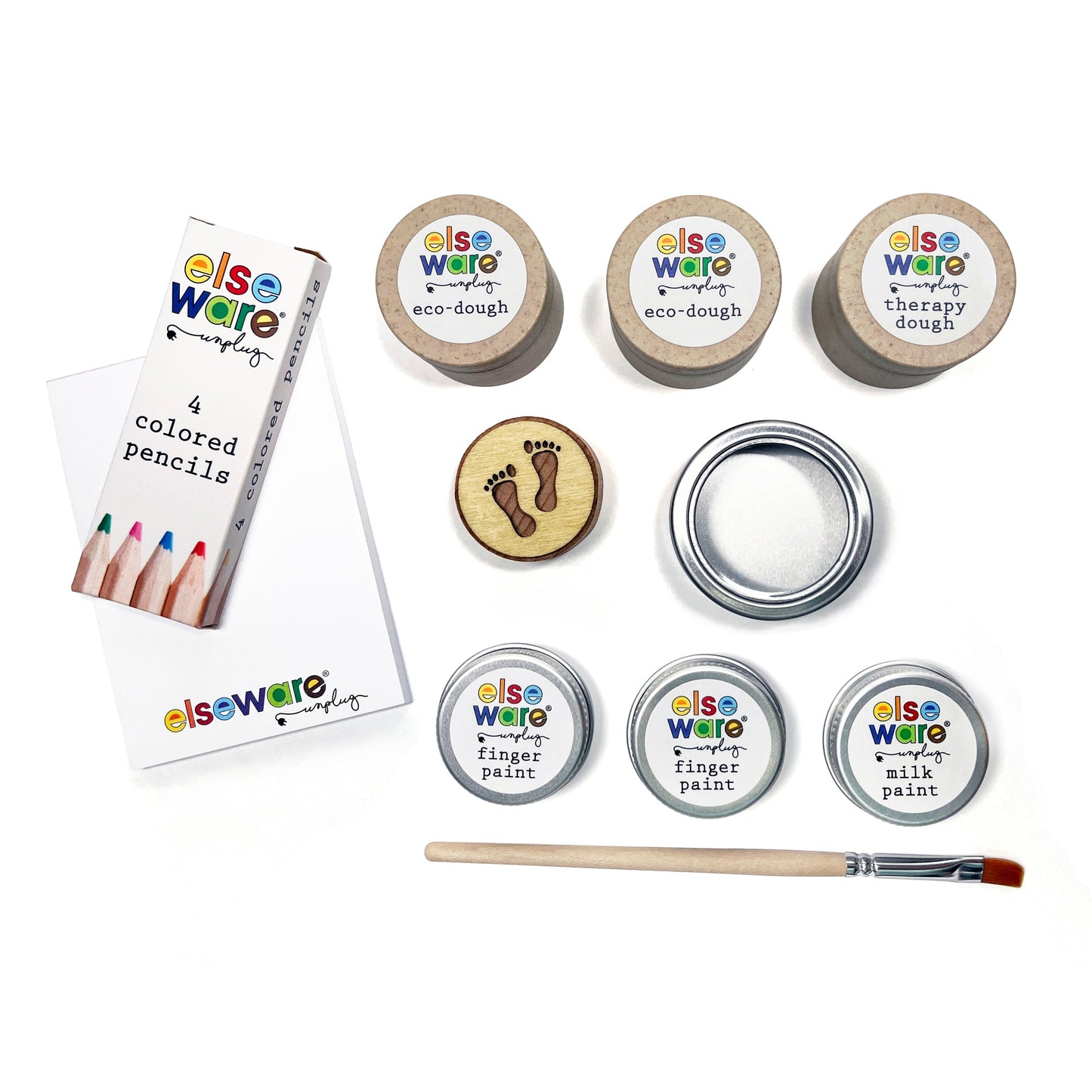 Assorted art supplies including eco-dough, colored pencils, finger paint, and a brush on a white background.