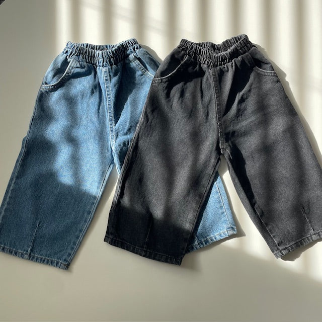 Two pairs of toddler denim dart pants, one in blue and one in black, displayed against a white background.