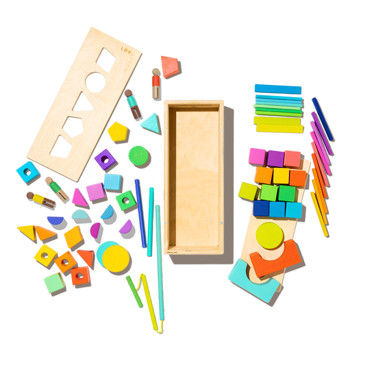 Colorful wooden geometric shapes and tools on a white background