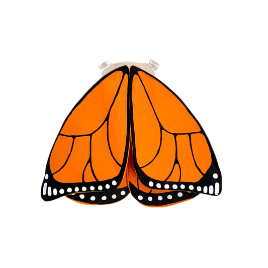 Butterfly wings with orange, black, and white pattern on a white background