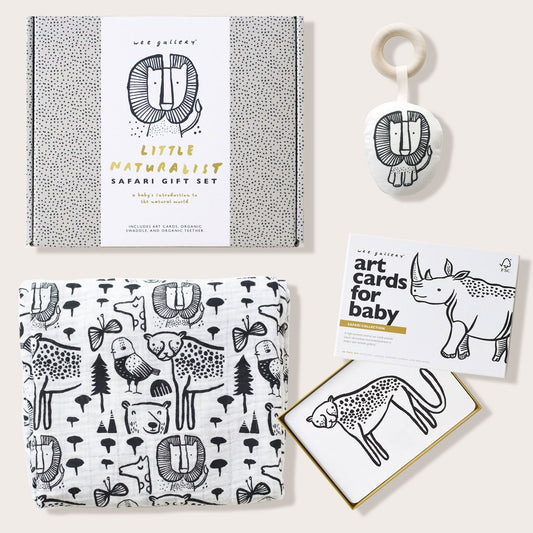 Collection of baby products including a book, card, and rattle with animal illustrations on a white background.