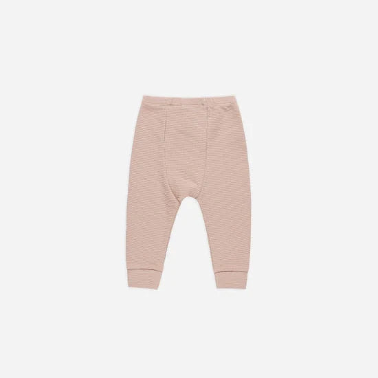 A pair of blush-colored organic cotton leggings with an elastic waistband.