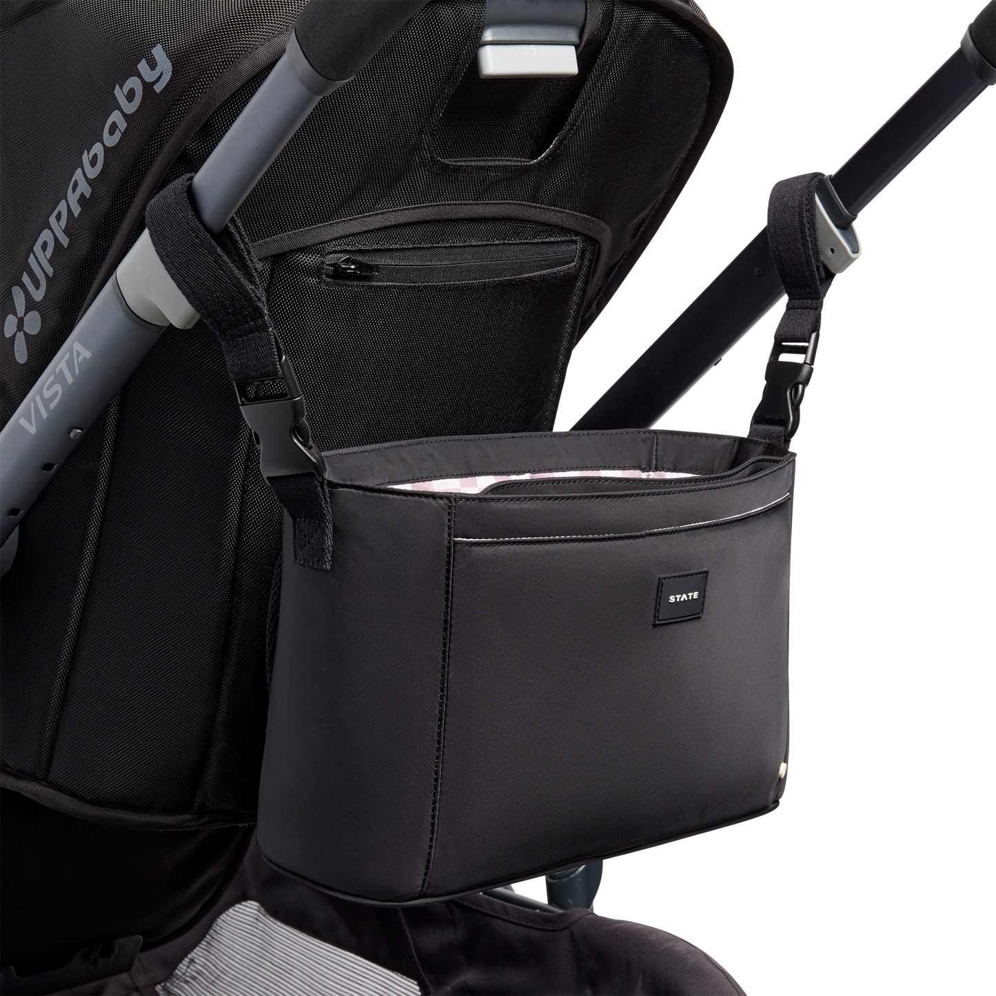 Black stroller organizer attached to a stroller on a white background