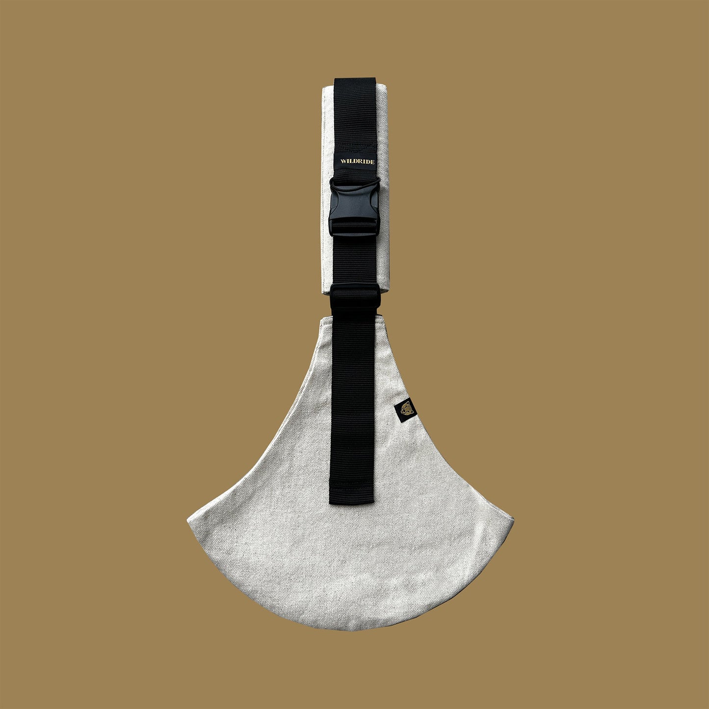 Toddler carrier with a black strap on a beige background