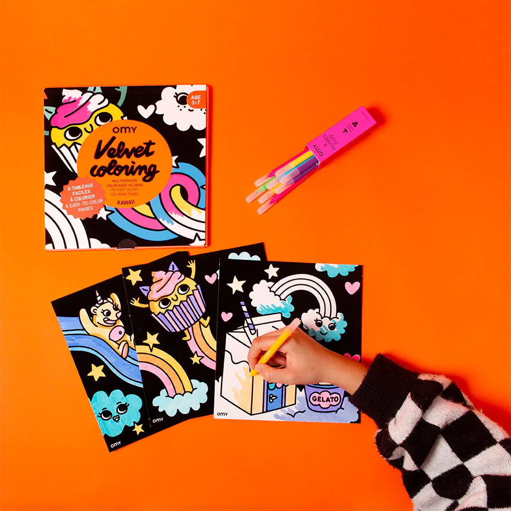 Coloring book set with markers on an orange background