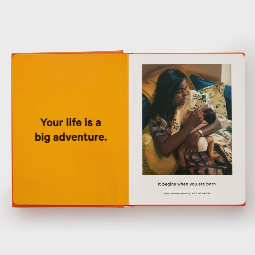 Open book with an orange page and a photo of a woman holding a child on the white page.