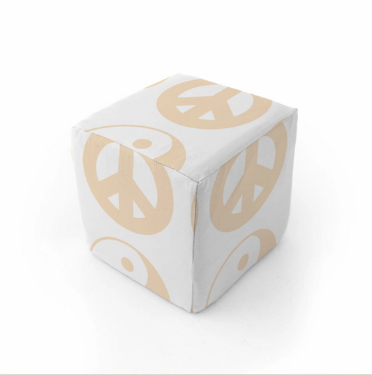 White cube with gold peace symbol design on a white background