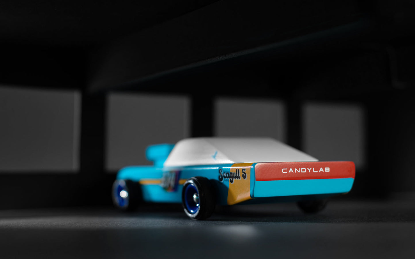 Toy car with 'CANDYLAB' branding on a dark background