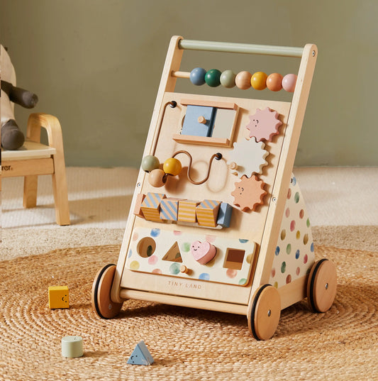 Wooden activity toy with wheels on a textured surface