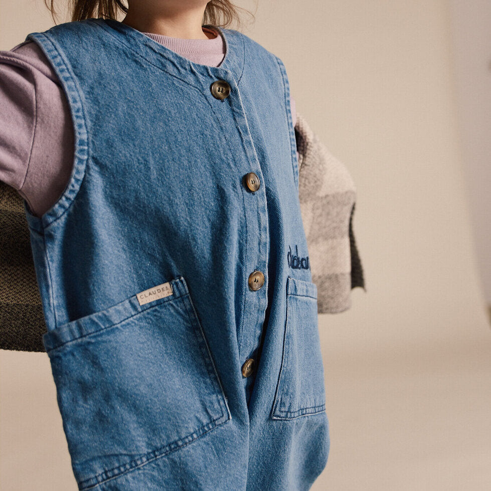 100% Cotton Denim Washed Overalls Sleeveless. Made from mid-weight textured rigid denim with a light wash and Claude and Co stitching.