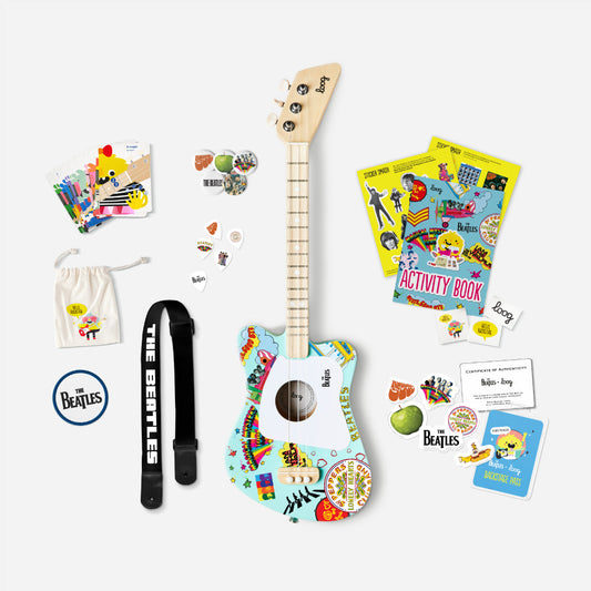 Colorful toy guitar with accessories on a white background