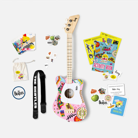 Children's guitar set with accessories on a white background