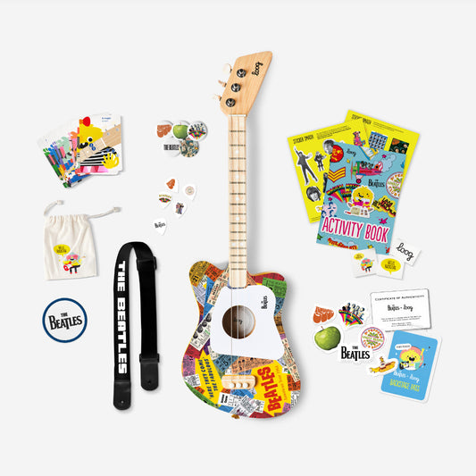 Colorful toy guitar with accessories on a white background