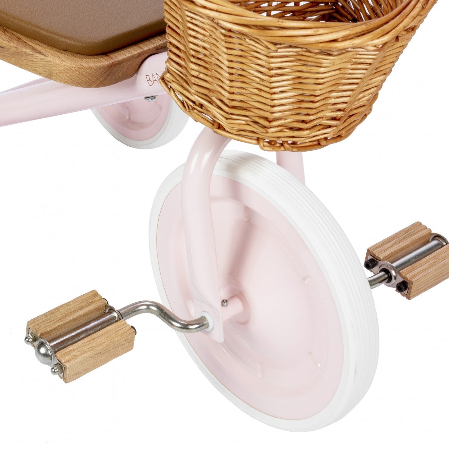 Close-up of a pink children's bike with wooden handlebar grips and basket on a white background