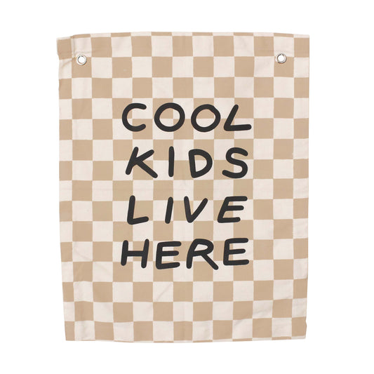 Checkered towel with 'Cool Kids Live Here' text on a white background
