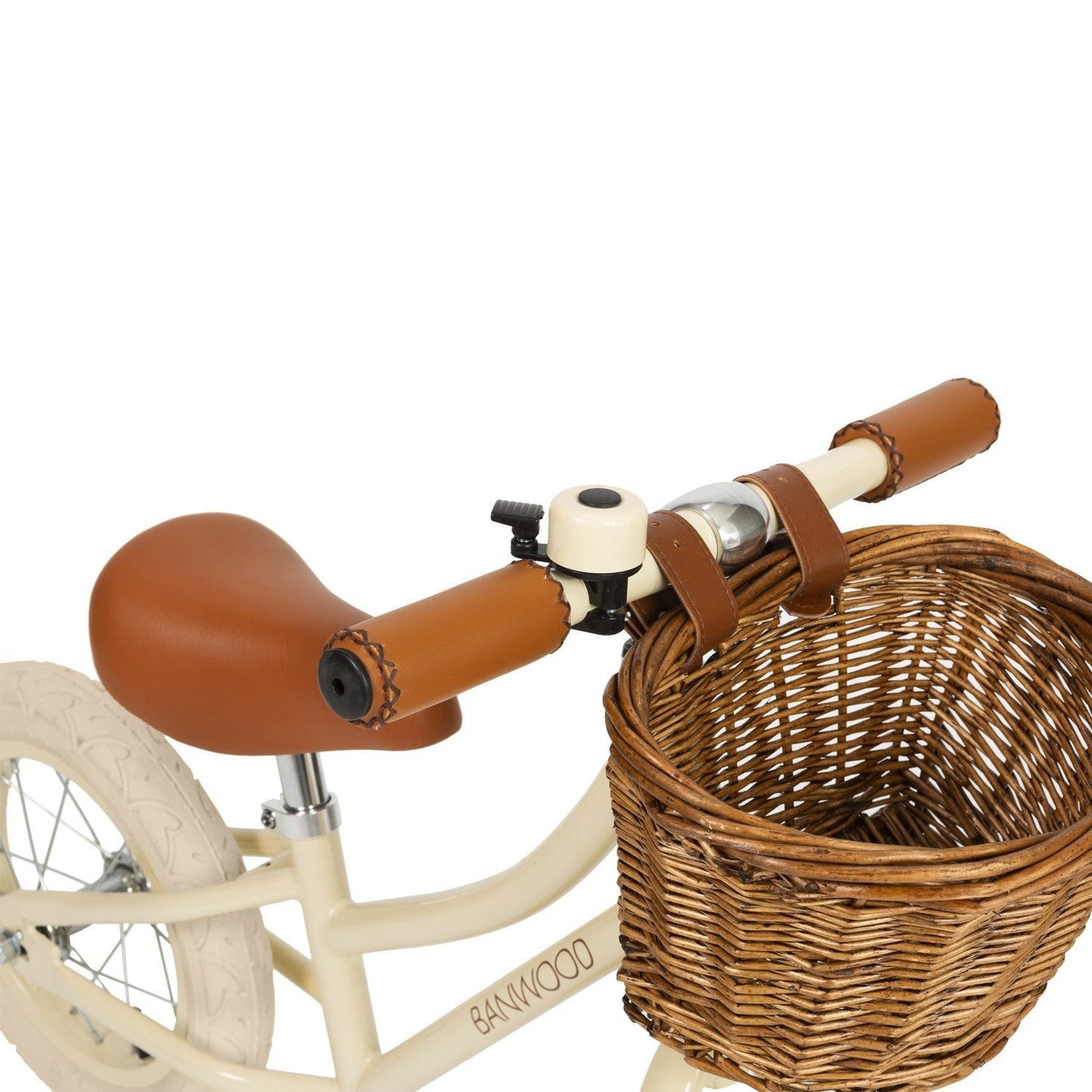 Children's balance bike with wicker basket and brown handlebar grips on a white background