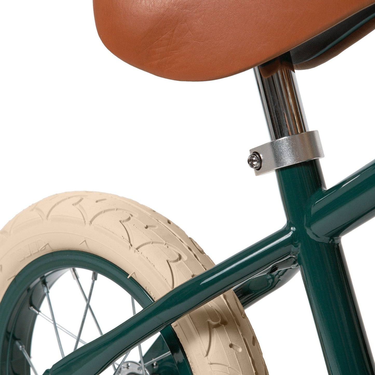Close-up of a bicycle with a brown seat and green frame on a white background