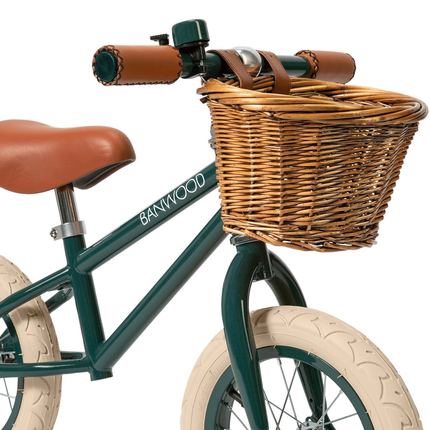 Children's bicycle with wicker basket and brown seat on a white background