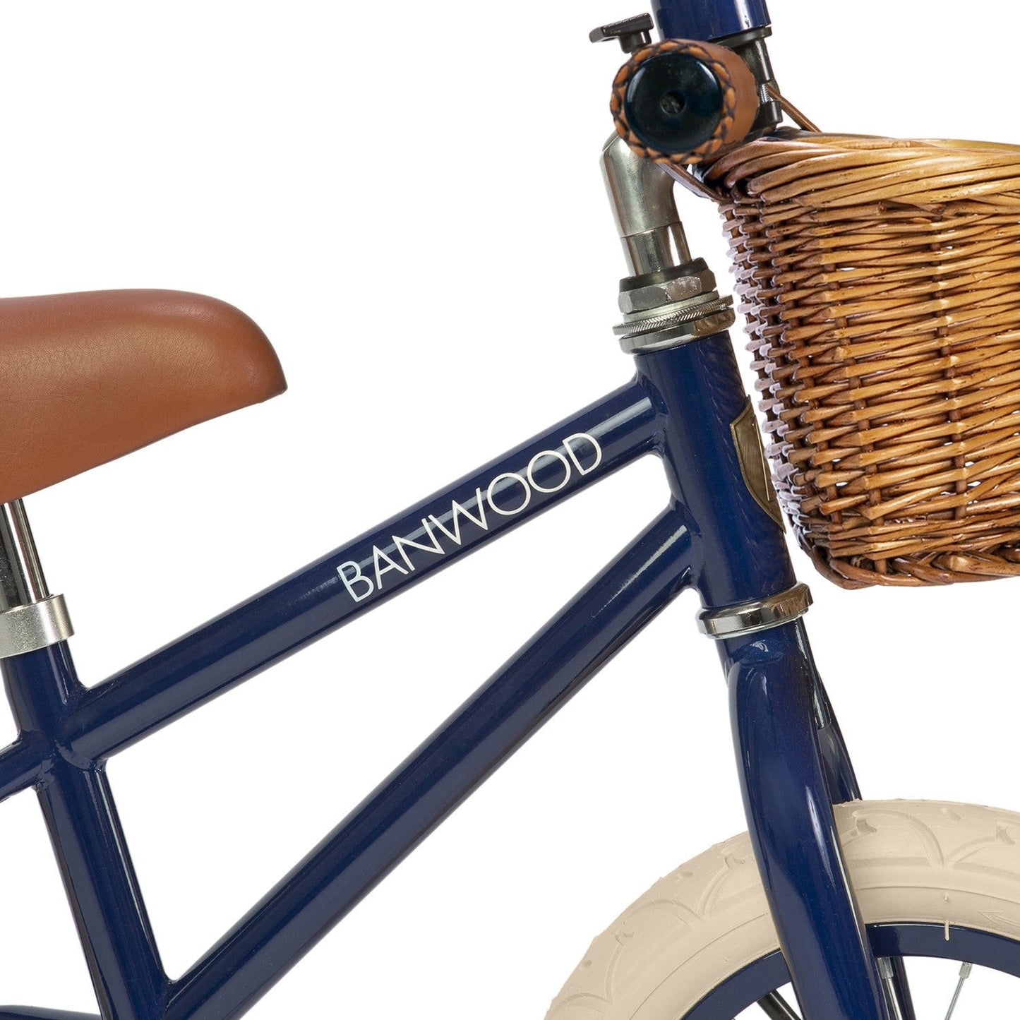 Blue children's bicycle with a wicker basket and brown seat on a white background