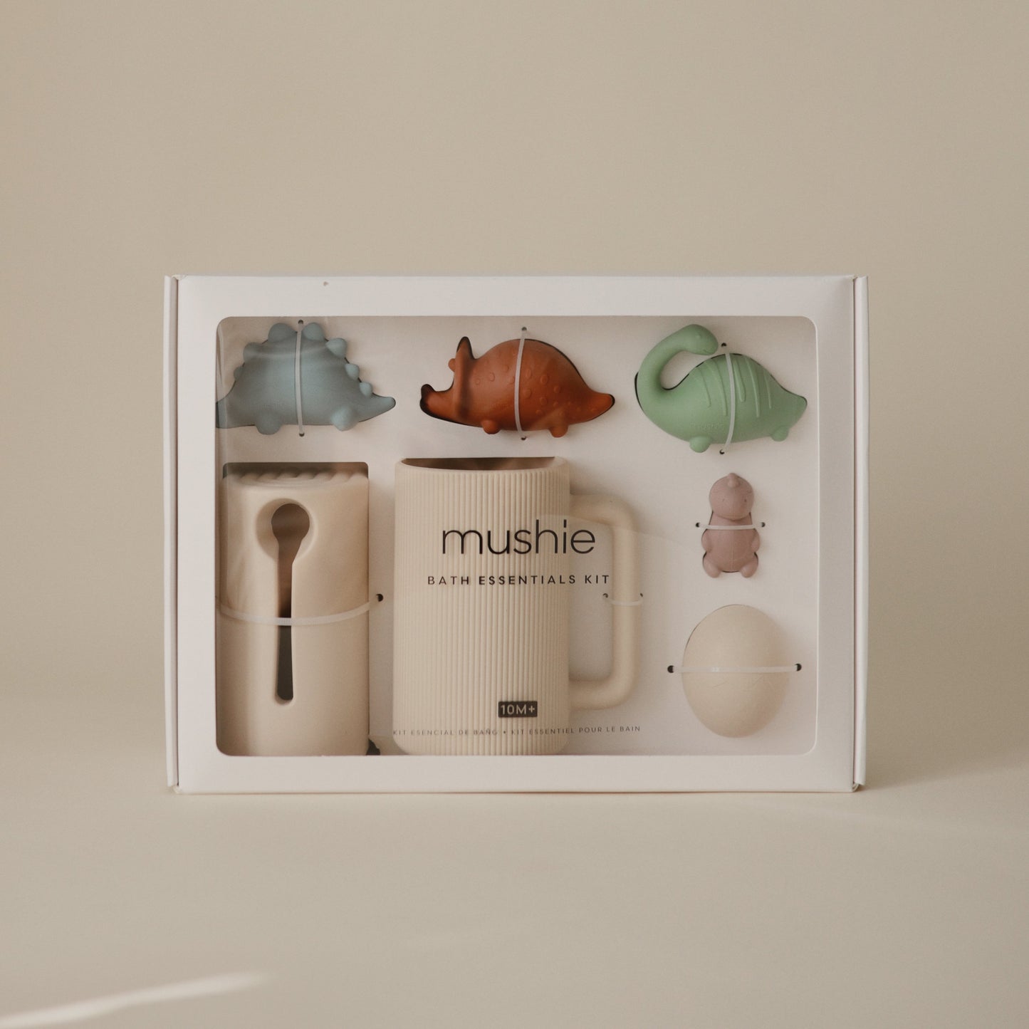 Mushie bath essentials kit with various items in a box on a beige background
