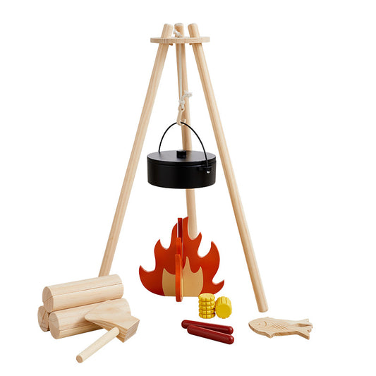 Wooden play set with campfire, logs, and accessories on a white background