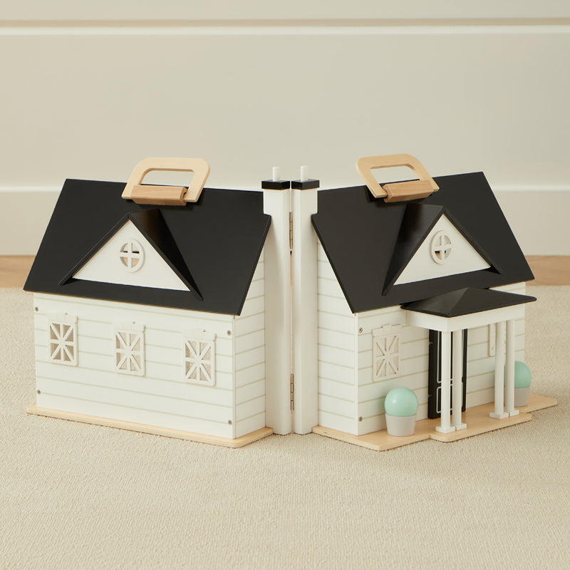 Bookend design resembling a house with black roofs and white bodies on a beige surface.
