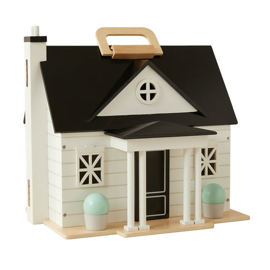Toy dollhouse with a black roof and white body on a white background