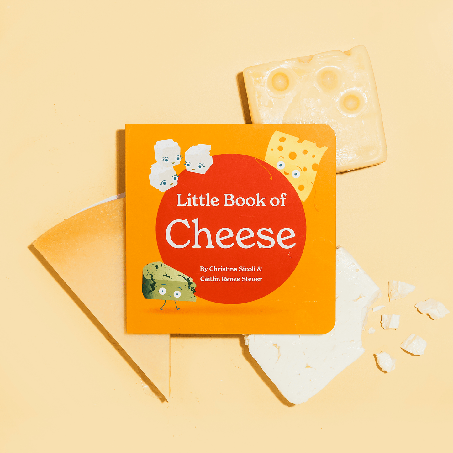 Children's book titled 'Little Book of Cheese' with cheese slices on a yellow background
