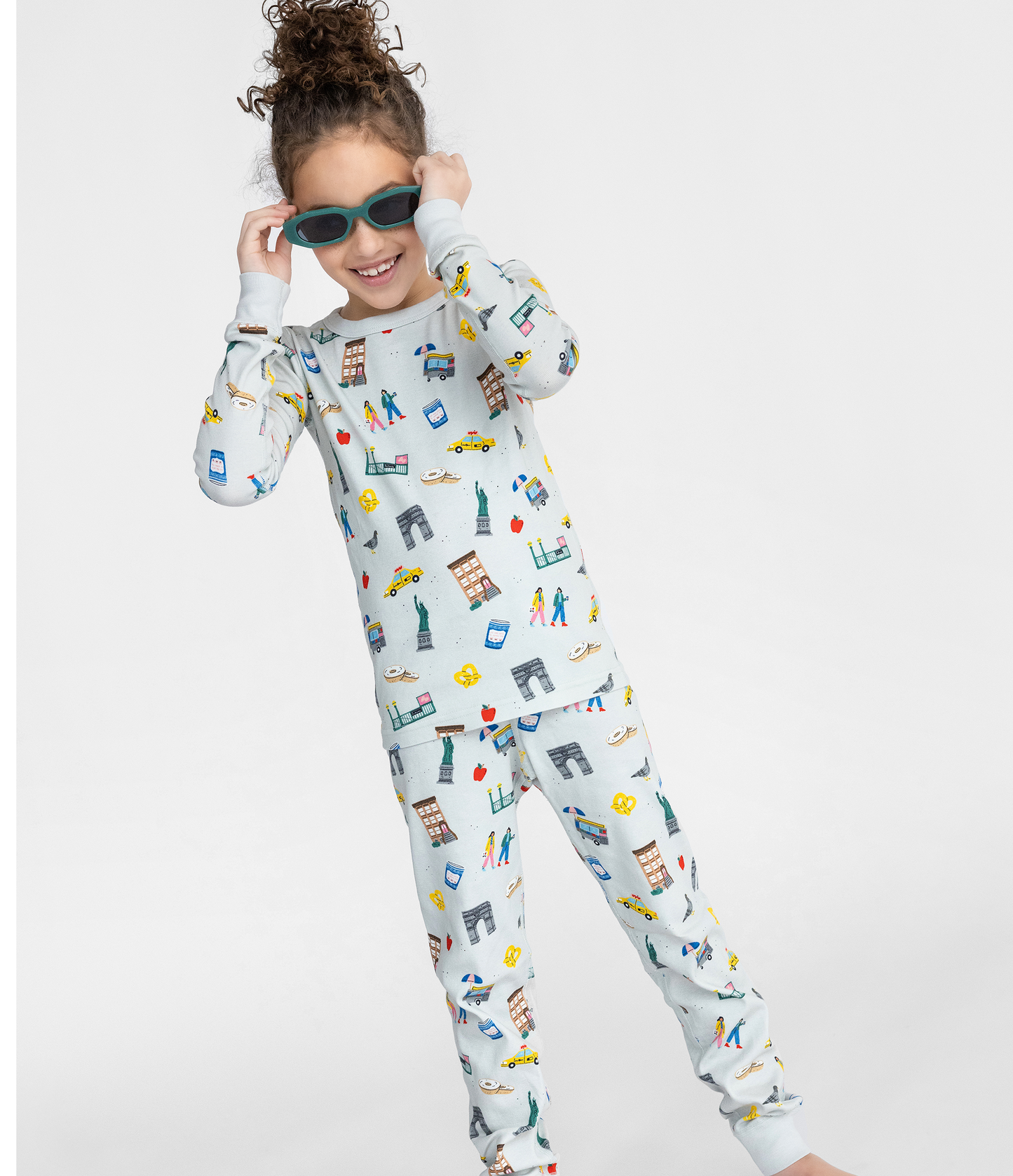Child wearing a NYC themed pajama set on a white background